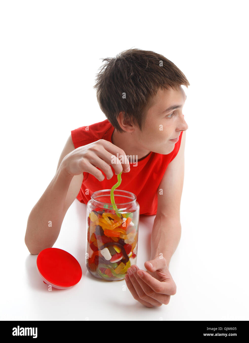 Boy with candy snake looking sideways Stock Photo