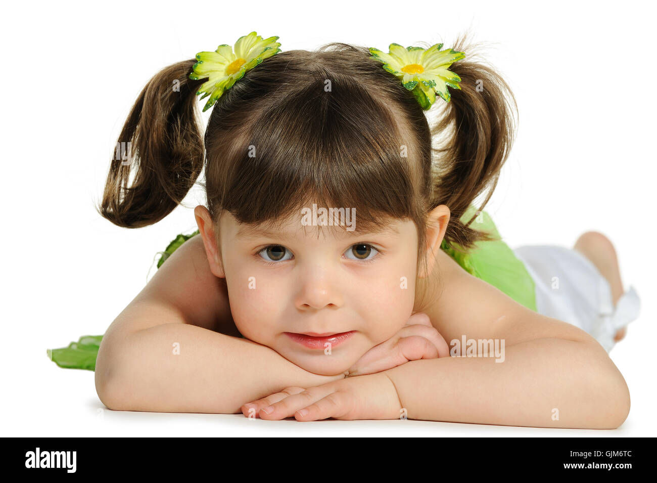 Pretty the little girl lies on the white Stock Photo - Alamy