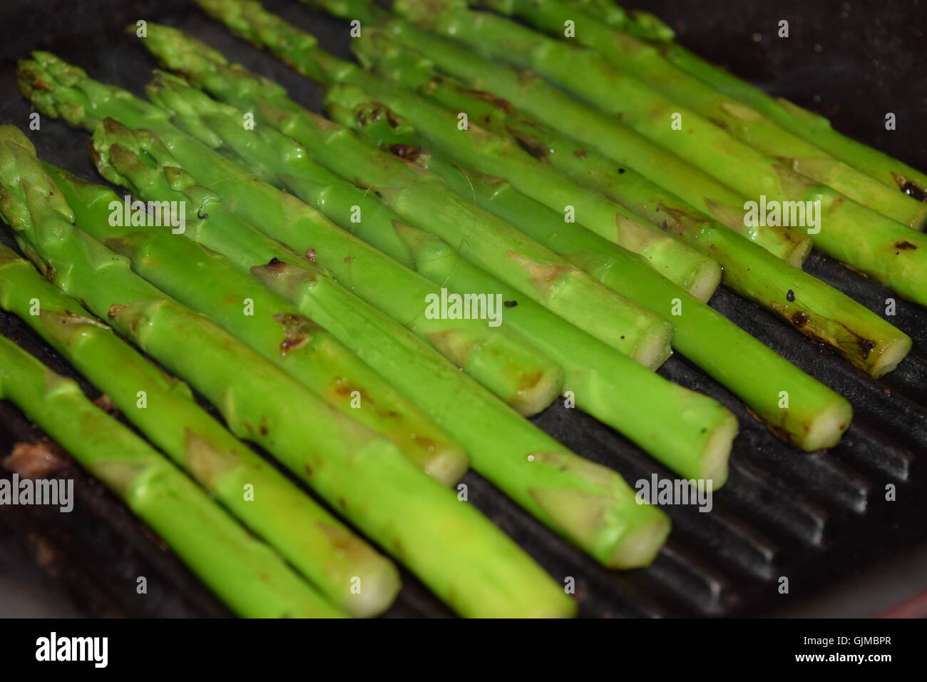Roasting Asparagus on an Iron Cast Grill Stock Photo Alamy