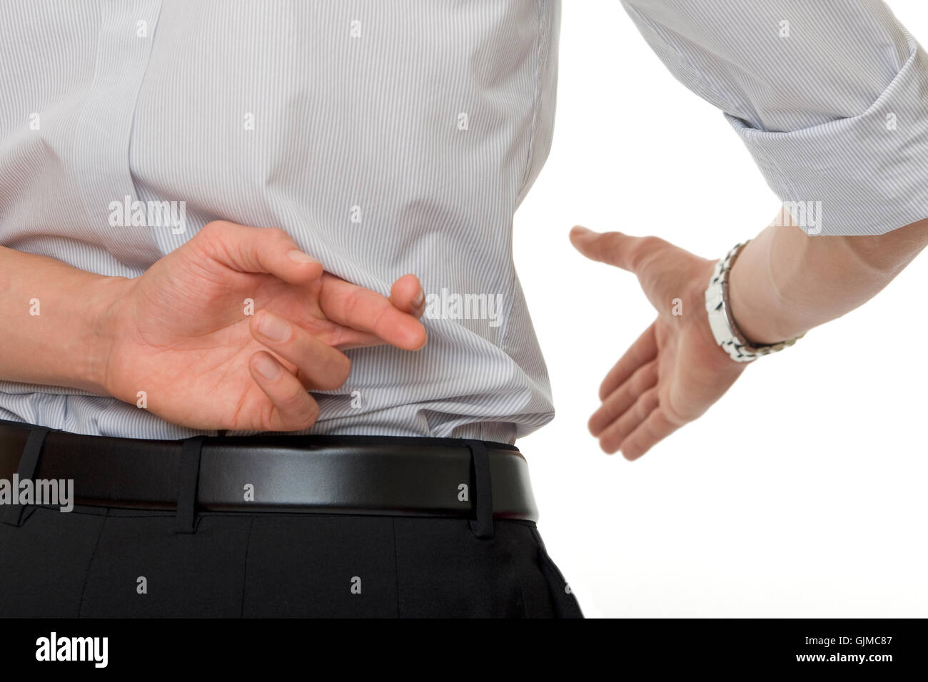 crossed fingers at handshake Stock Photo