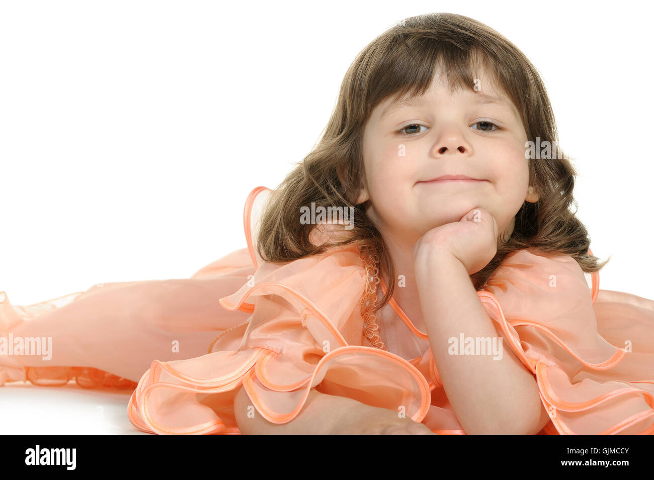 Pretty the little girl lies on the white Stock Photo - Alamy