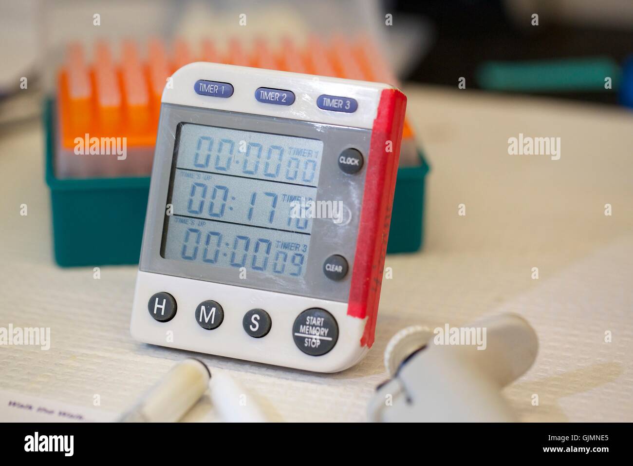 Digital timer on laboratory bench. Stock Photo