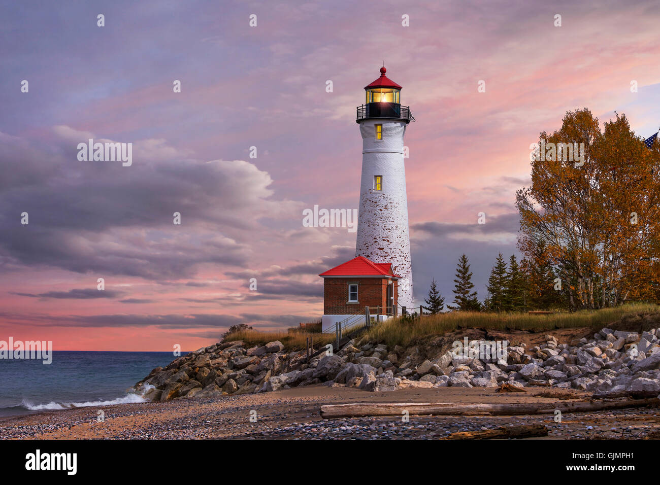 As daylight begins yielding to twilight, The Crisp Point Lighthouse at sunset on Lake Superior, Upper Peninsula, Michigan, USA Stock Photo