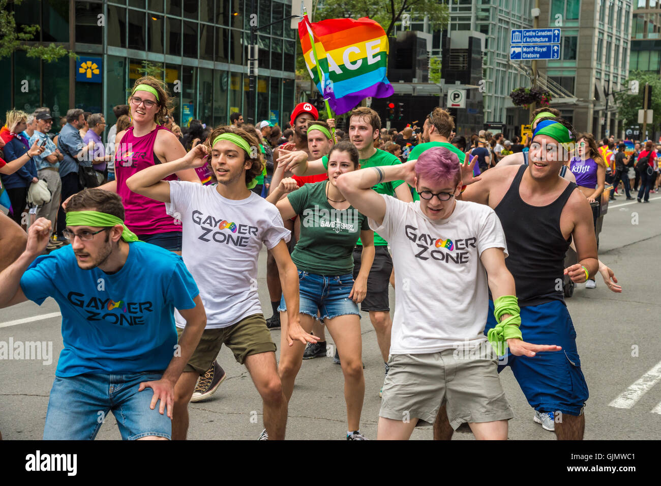 Montreal, CA - 14 August 2016: People holding gay rainbow flags take part in 2016 Gay Pride Parade Stock Photo