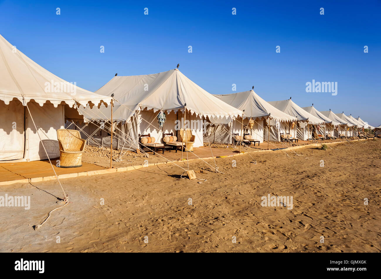 A Desert Camp with white tents and sitting arrangement, in Desert national Park, SAM dunes of Indian Thar Desert, Copy Space Stock Photo