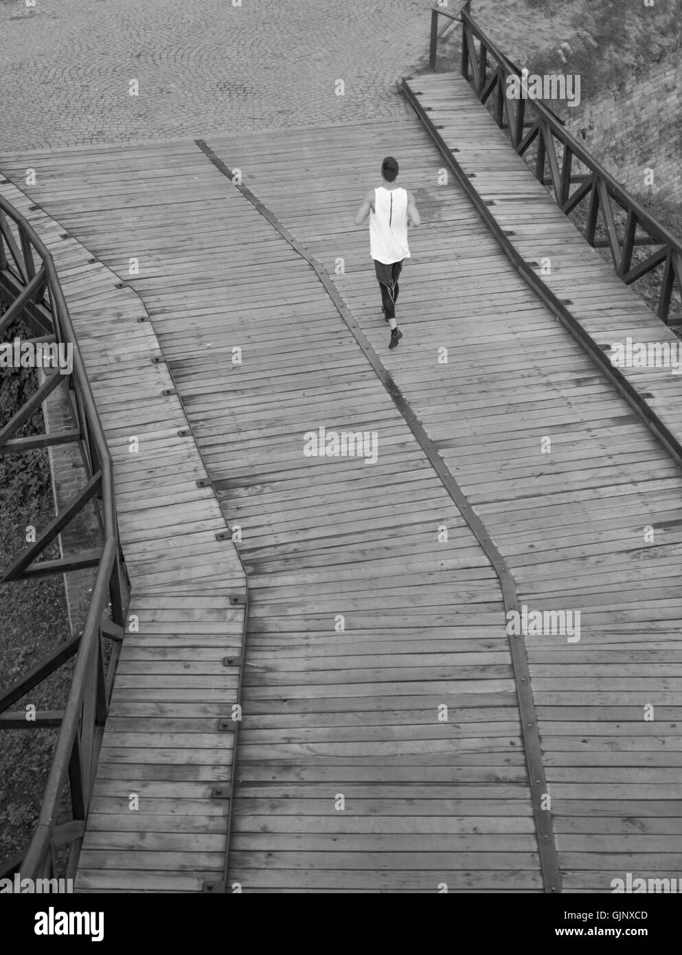 black and white one man run jogging elevated view rear back Stock Photo