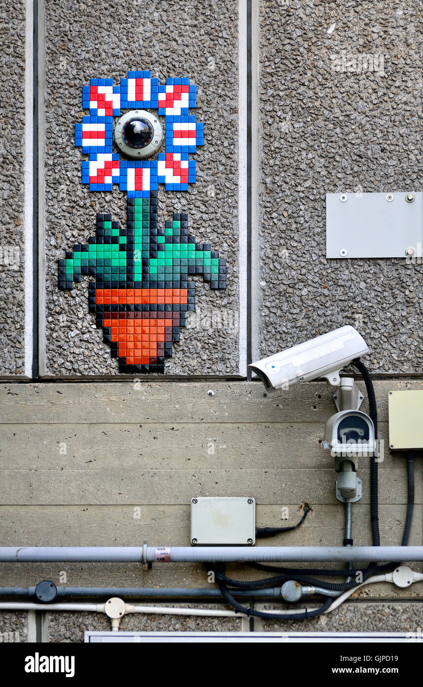 London England, UK. Surveillance cameras by the National Theatre, South Bank. One disguised as a mosaic flower by French urban artist Invader Stock Photo