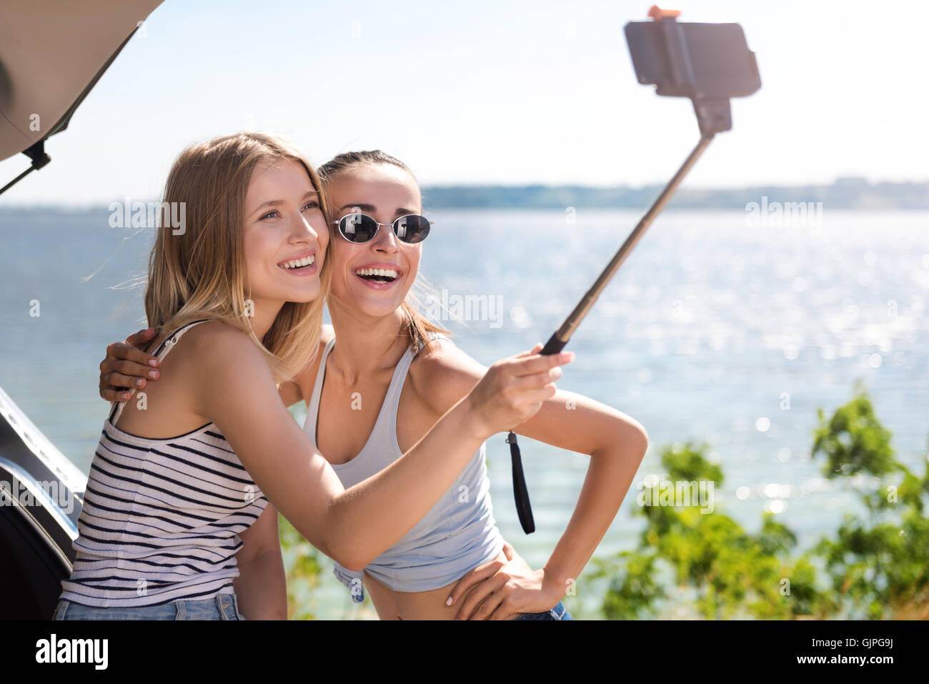 Cheerful friends making selfies Stock Photo