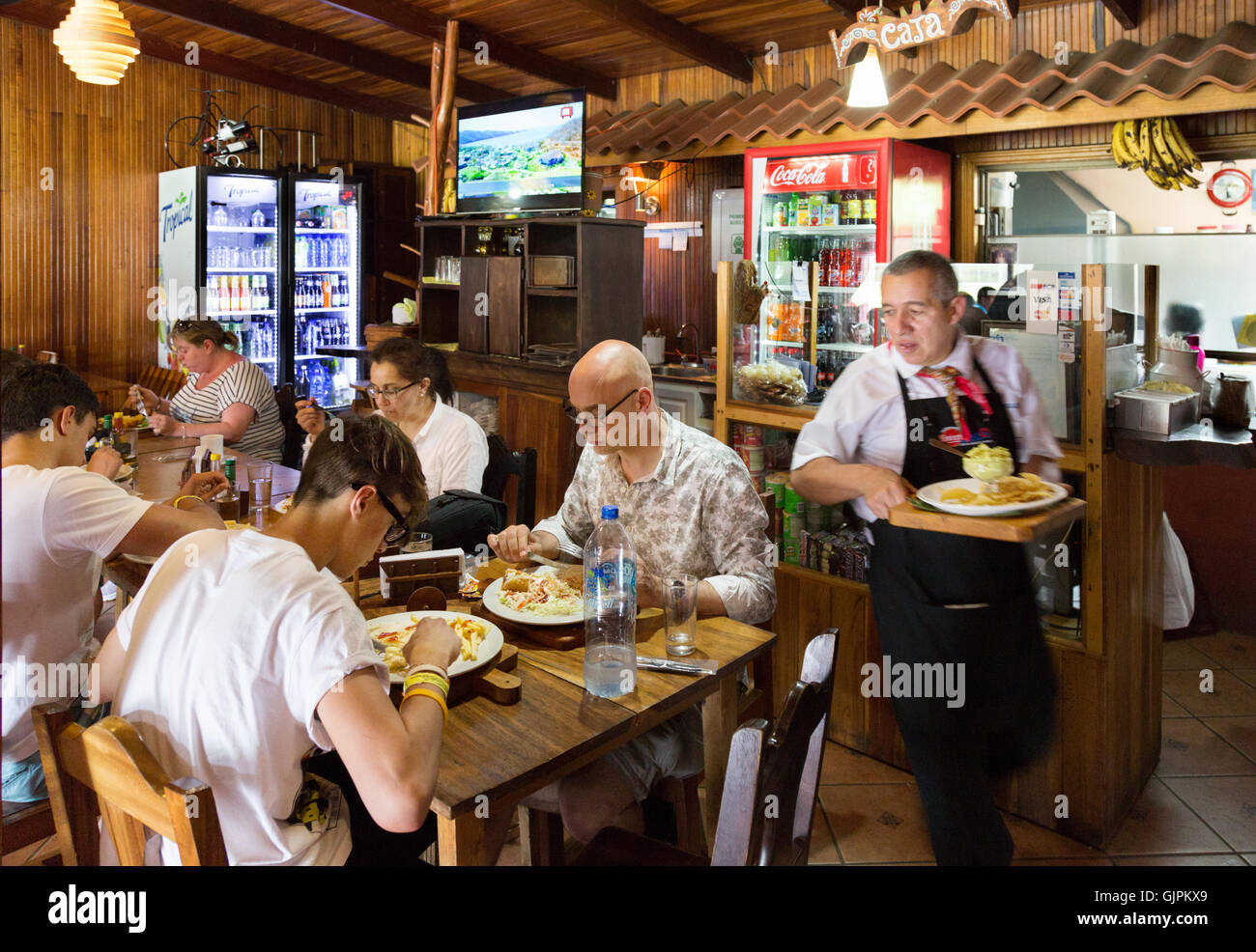 Tourists and a waiter in a restaurant, Monteverde, Costa Rica, Central America Stock Photo