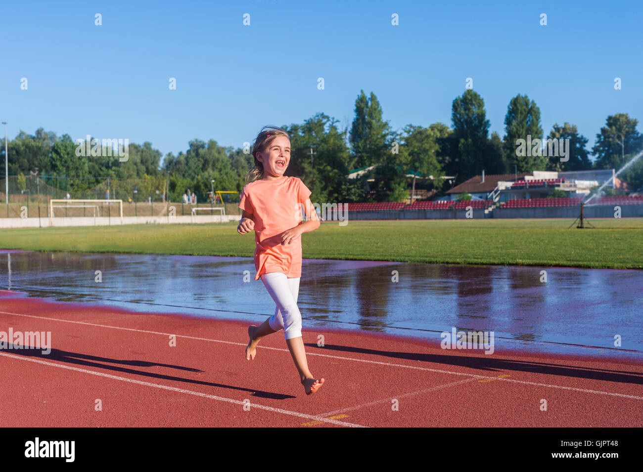 Happy girl run on the track Stock Photo Alamy