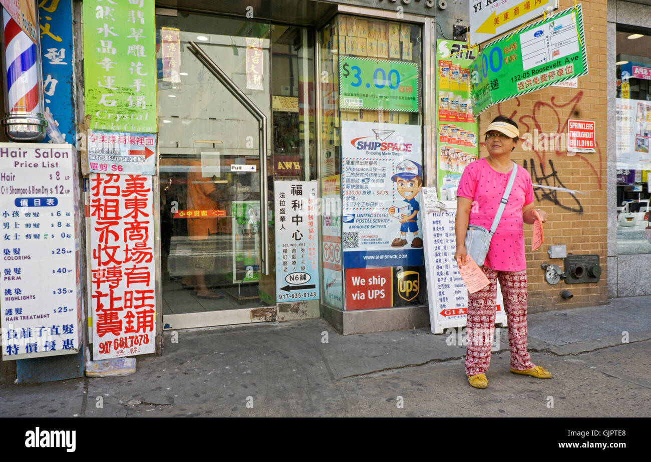 An Asian American woman handing out fliers for a beauty salon on Roosevelt Ave. in downtown Flushing, Queens, New York City. Stock Photo