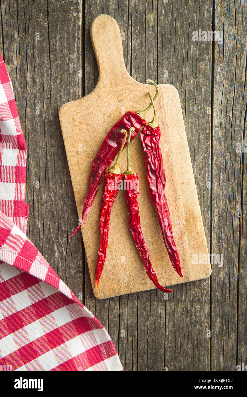 Dried chili peppers on cutting board. Top view Stock Photo - Alamy
