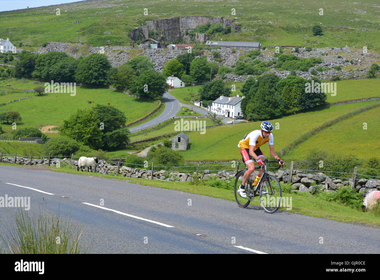 Cyclist on steep hill near Merrivale, Dartmoor National Park, Devon, England Stock Photo