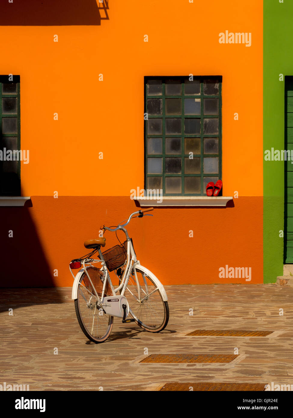 Orange rendered exterior of a traditional house on the island of Burano. Venice, Italy. Stock Photo
