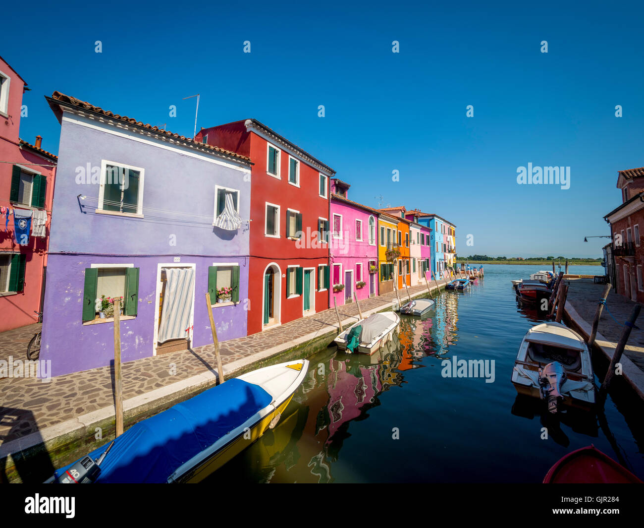 The traditional colourful painted canal side houses of the island of Burano. Venice, Italy. Stock Photo