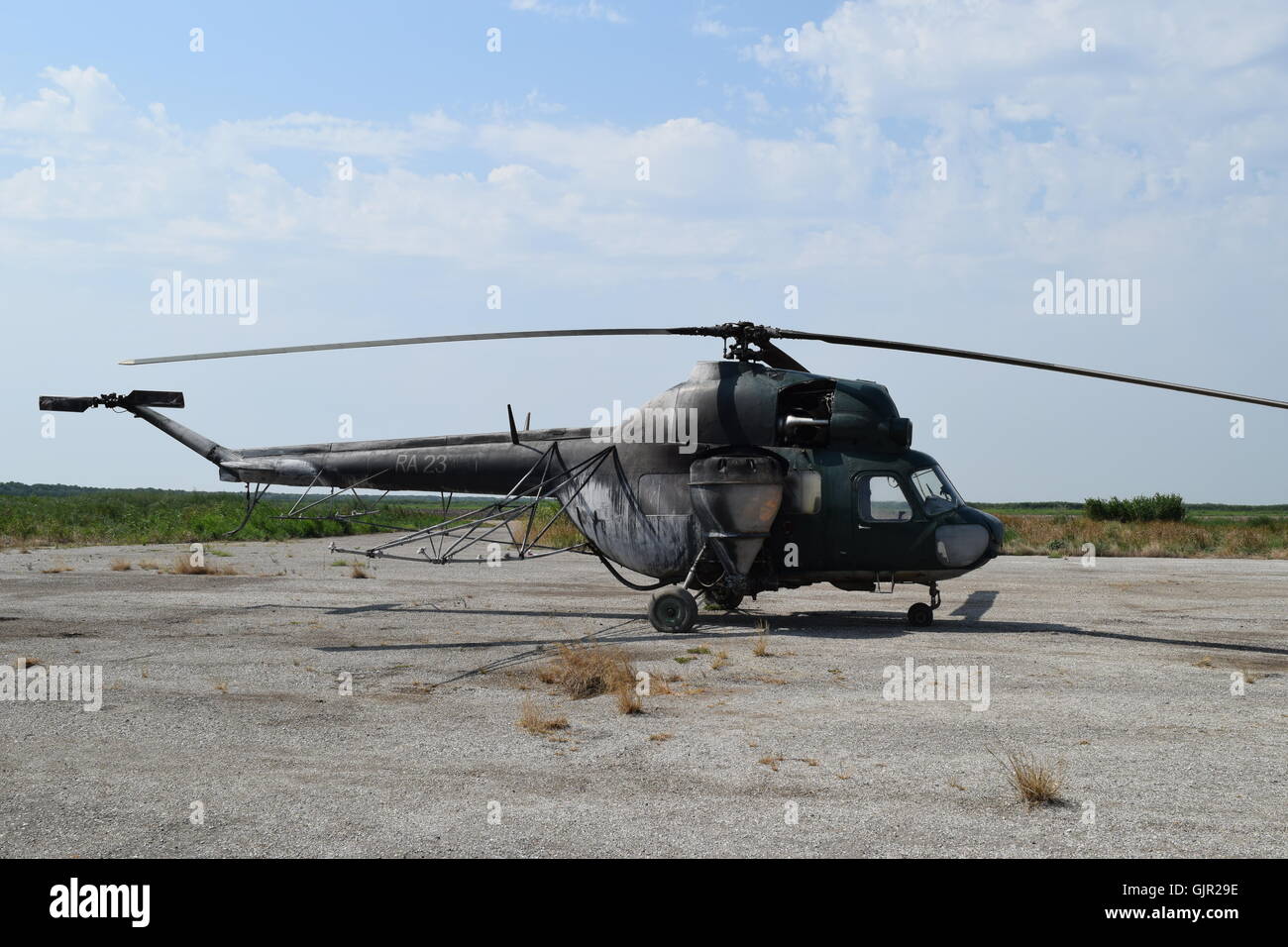 Old helicopter spraying fields. Helicopter spraying fertilizer Stock