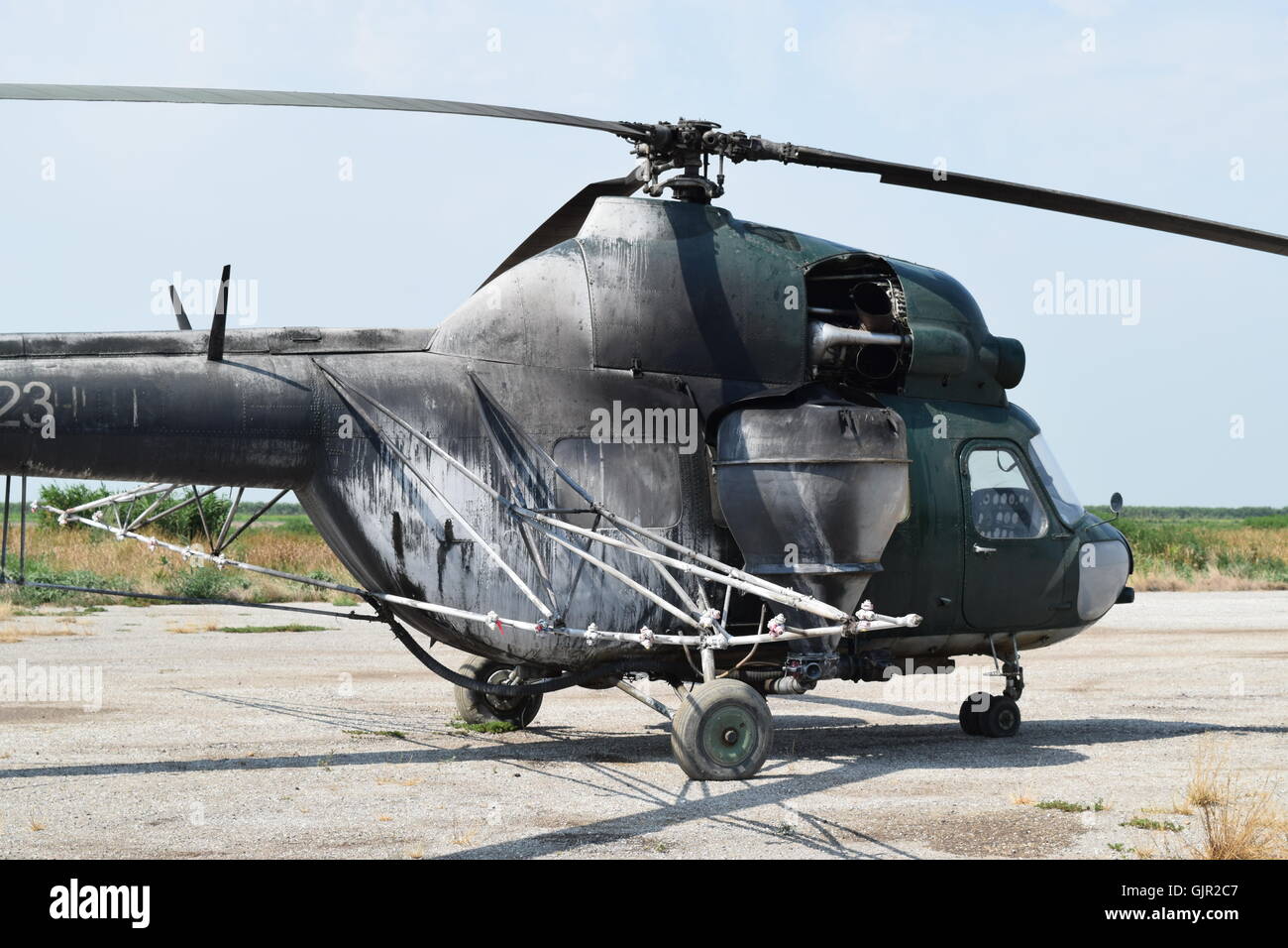 Old helicopter spraying fields. Helicopter spraying fertilizer Stock