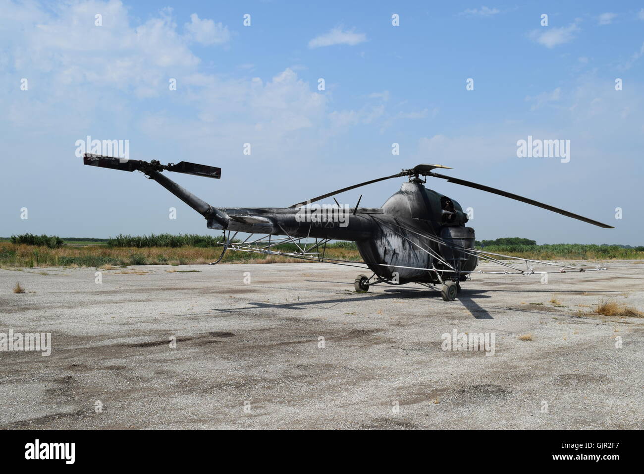 Old helicopter spraying fields. Helicopter spraying fertilizer Stock