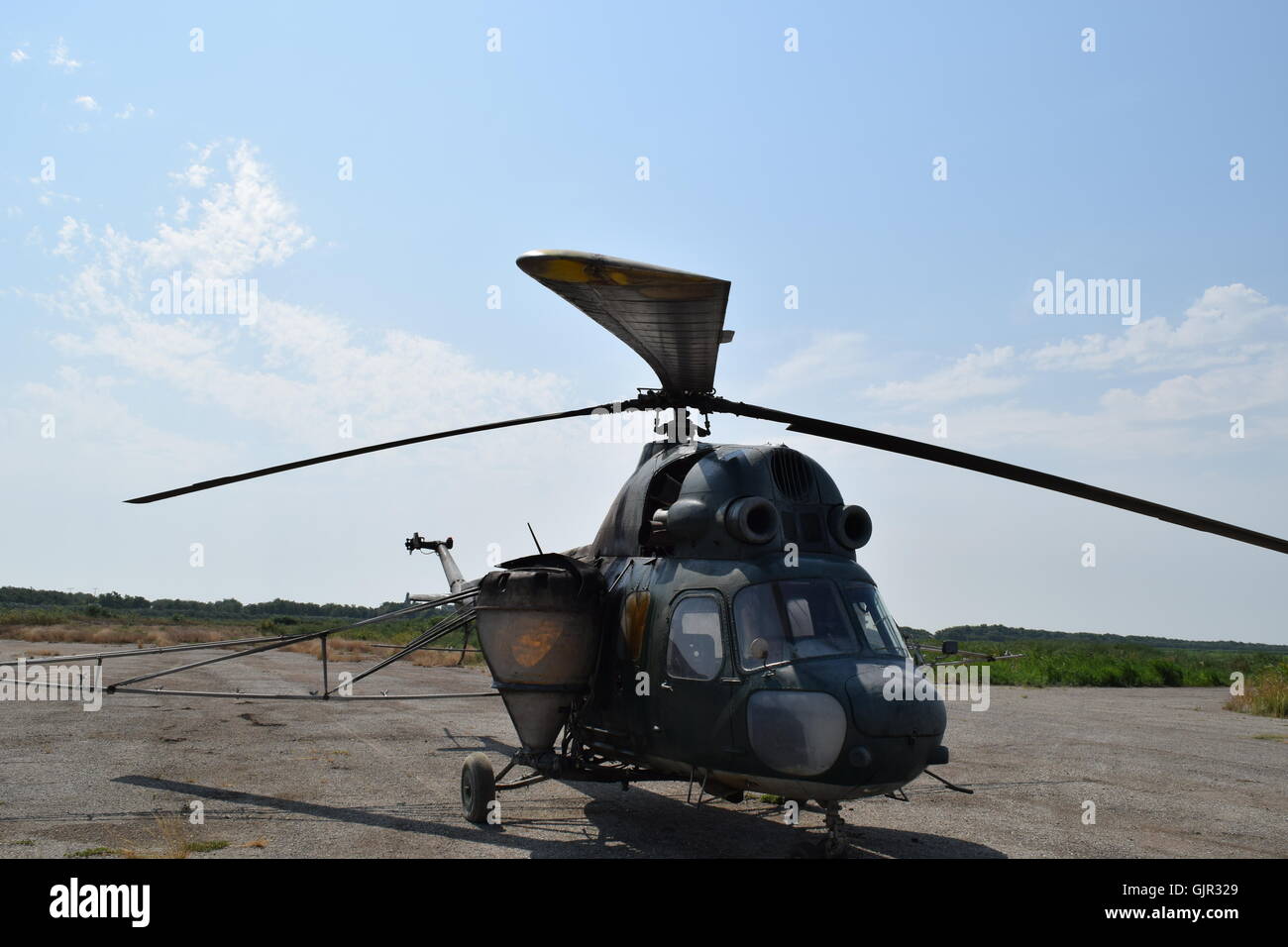 Old helicopter spraying fields. Helicopter spraying fertilizer Stock