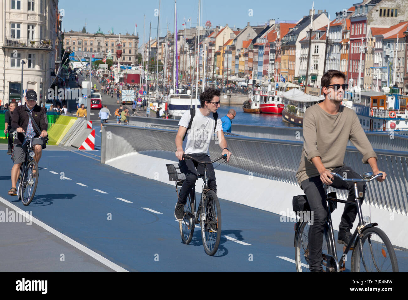 Cyclists or cyclers on the new pedestrian and cyclist bridge Inderhavnsbroen, Inner Harbour Bridge, connecting Nyhavn and Christianshavn, Copenhagen. Stock Photo