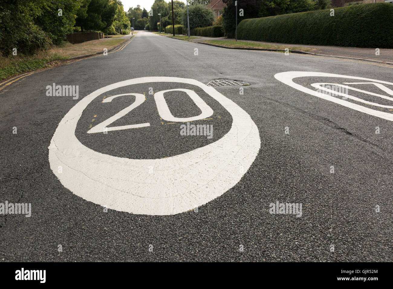 Close up wide angle view of 20 miles per hour mph speed limit signs painted on a road in Cambrudge UK Stock Photo