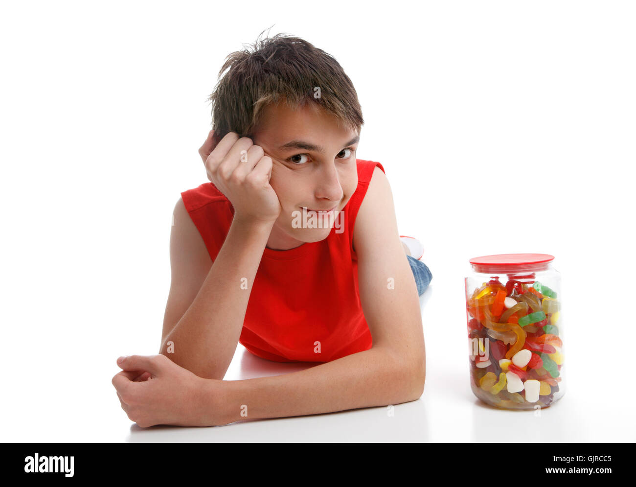 Boy beside an assortment of mixed confectionery Stock Photo
