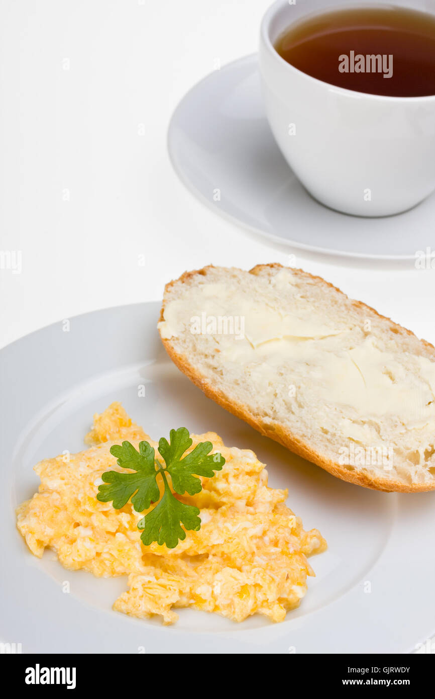 scrambled eggs and bun on a plate Stock Photo - Alamy