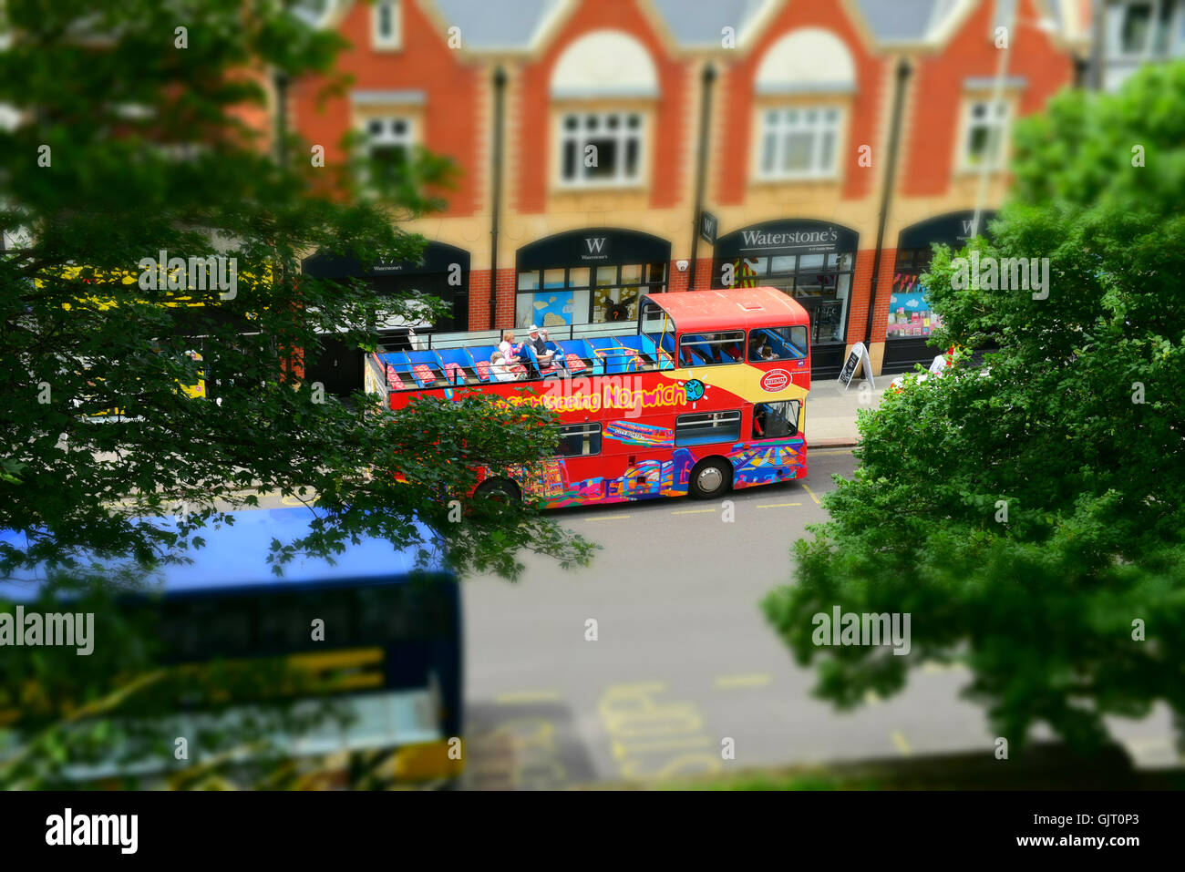 Open top bus on a sight seeing tour in Norwich City Centre, shot in miniature effect. Stock Photo