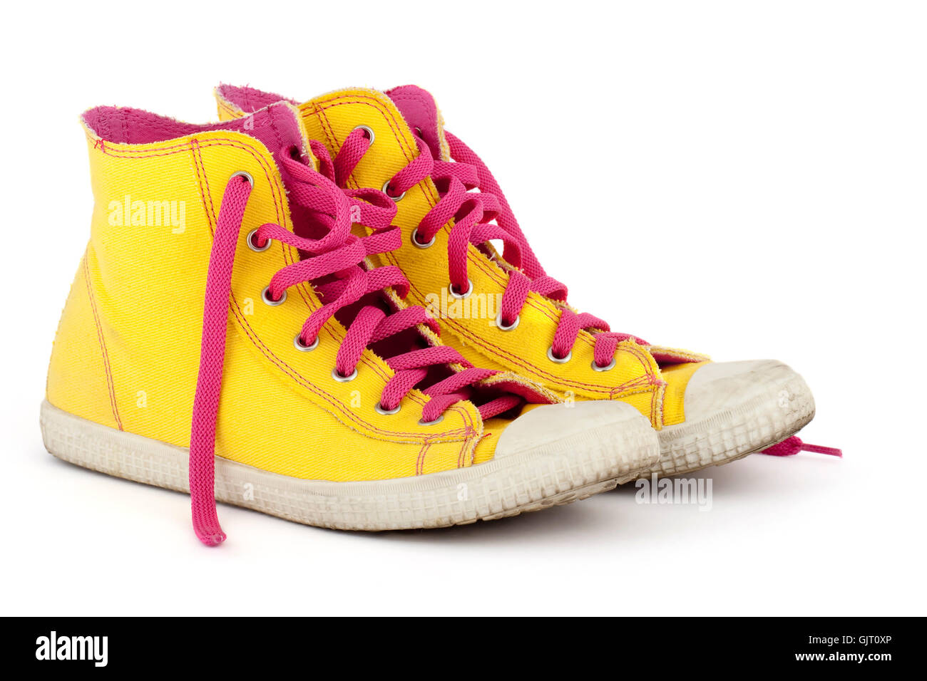 yellow shoes with pink shoelace Stock Photo