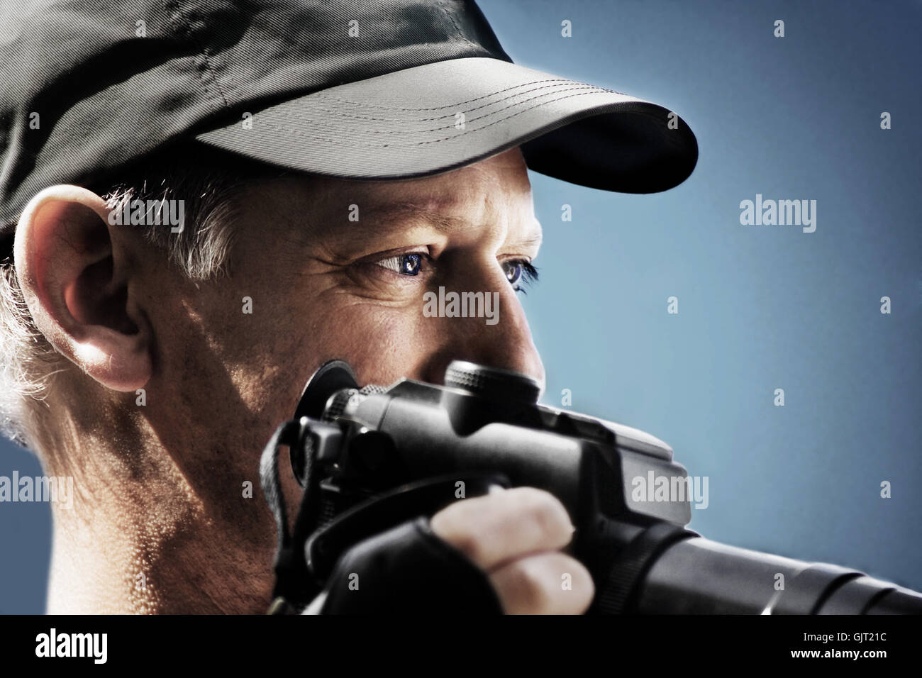 photographer with camera looks focused Stock Photo Alamy