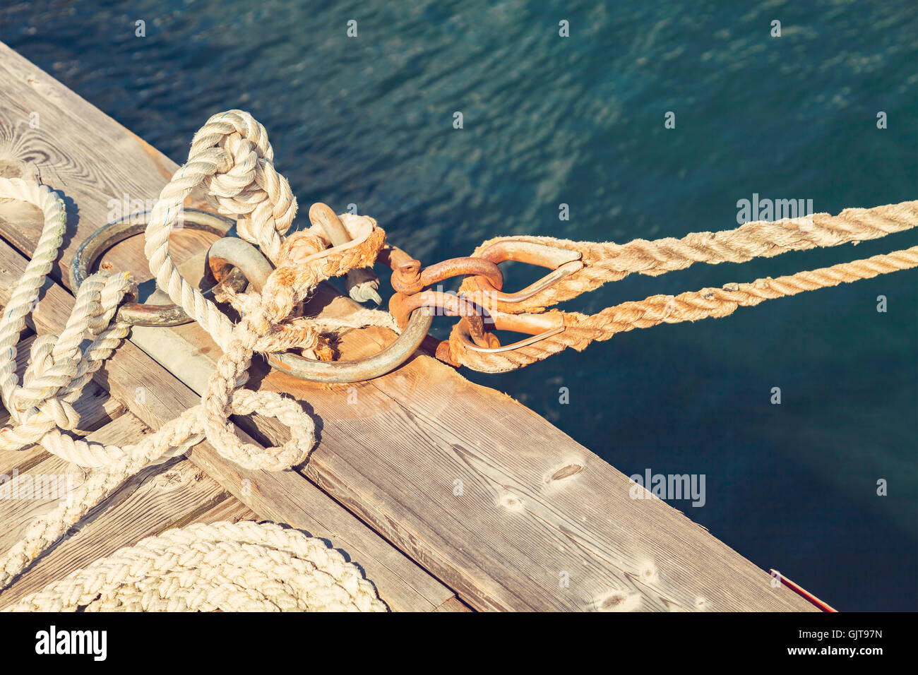 Image of old boat rope tied to the pier Stock Photo - Alamy