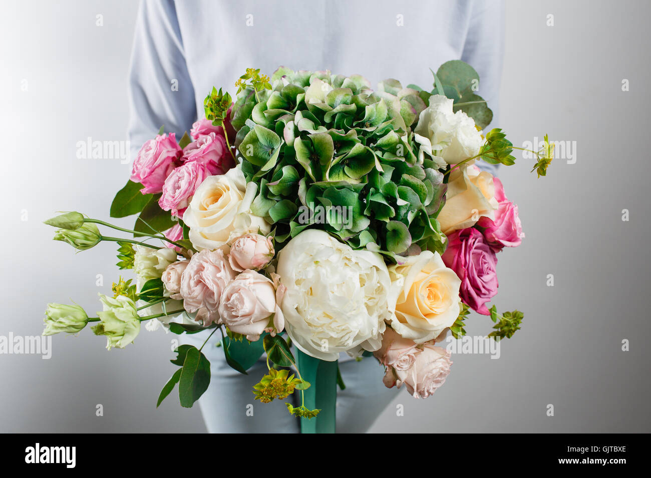 flower composition with hydrangea and peonies. Color pink, green, lavander, blue. Kraft paper. crisp packaging Stock Photo