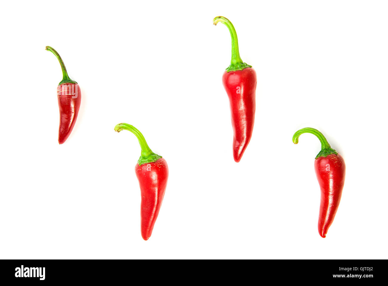 Four ripe red Chilli peppers on over white Stock Photo - Alamy