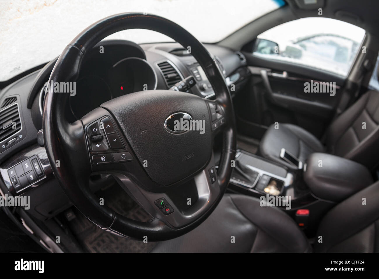 Driver seat and steering wheel are in car interior, wide angle view