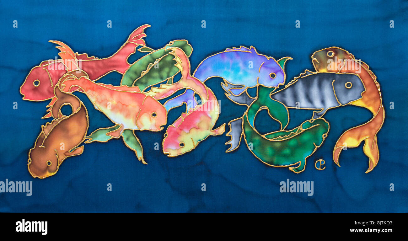 Photograph of silk painting of multi-coloured Koi carp against blue background using steam fixed dyes by Paula Chapman. Stock Photo