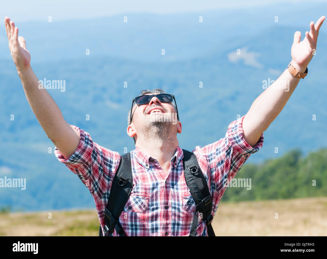 Backpacker feeling happy and victorious on top of the mountain Stock ...