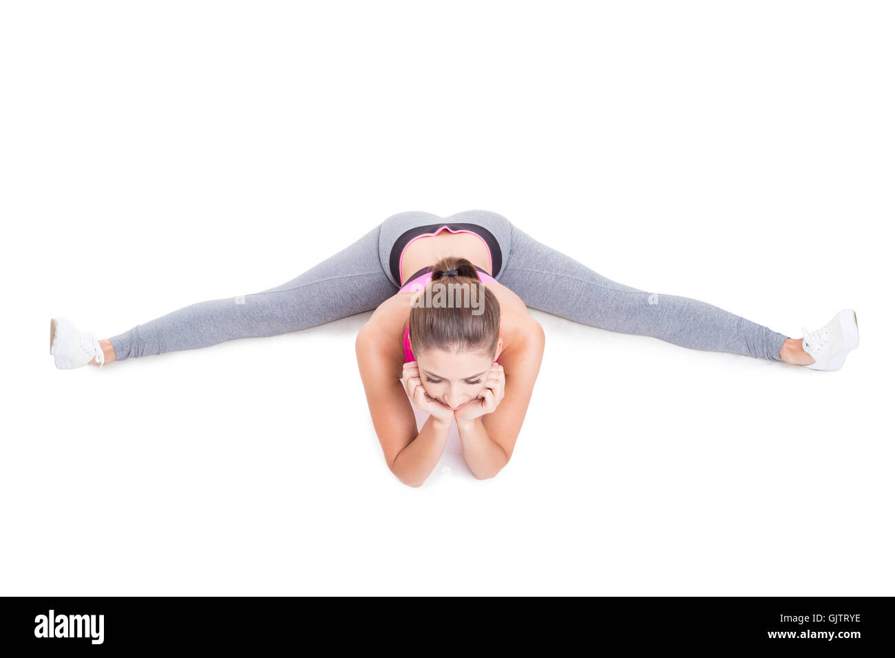 Up View Of Fit Girl Sitting With Leg Spread Isolated On White