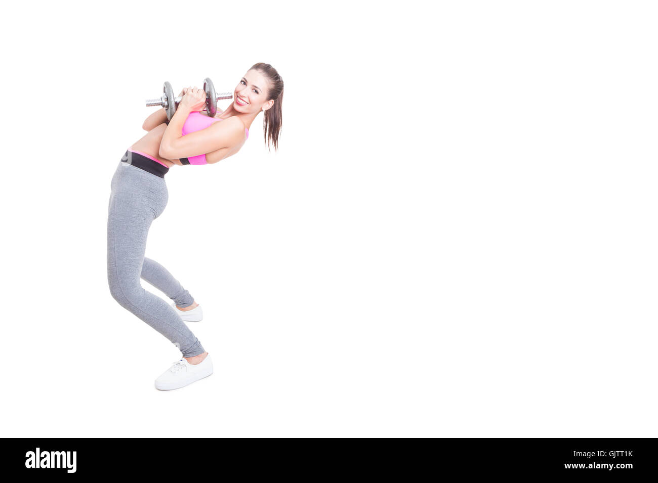 Woman working out bending over back holding dumbbell isolated on white background with copy text space Stock Photo