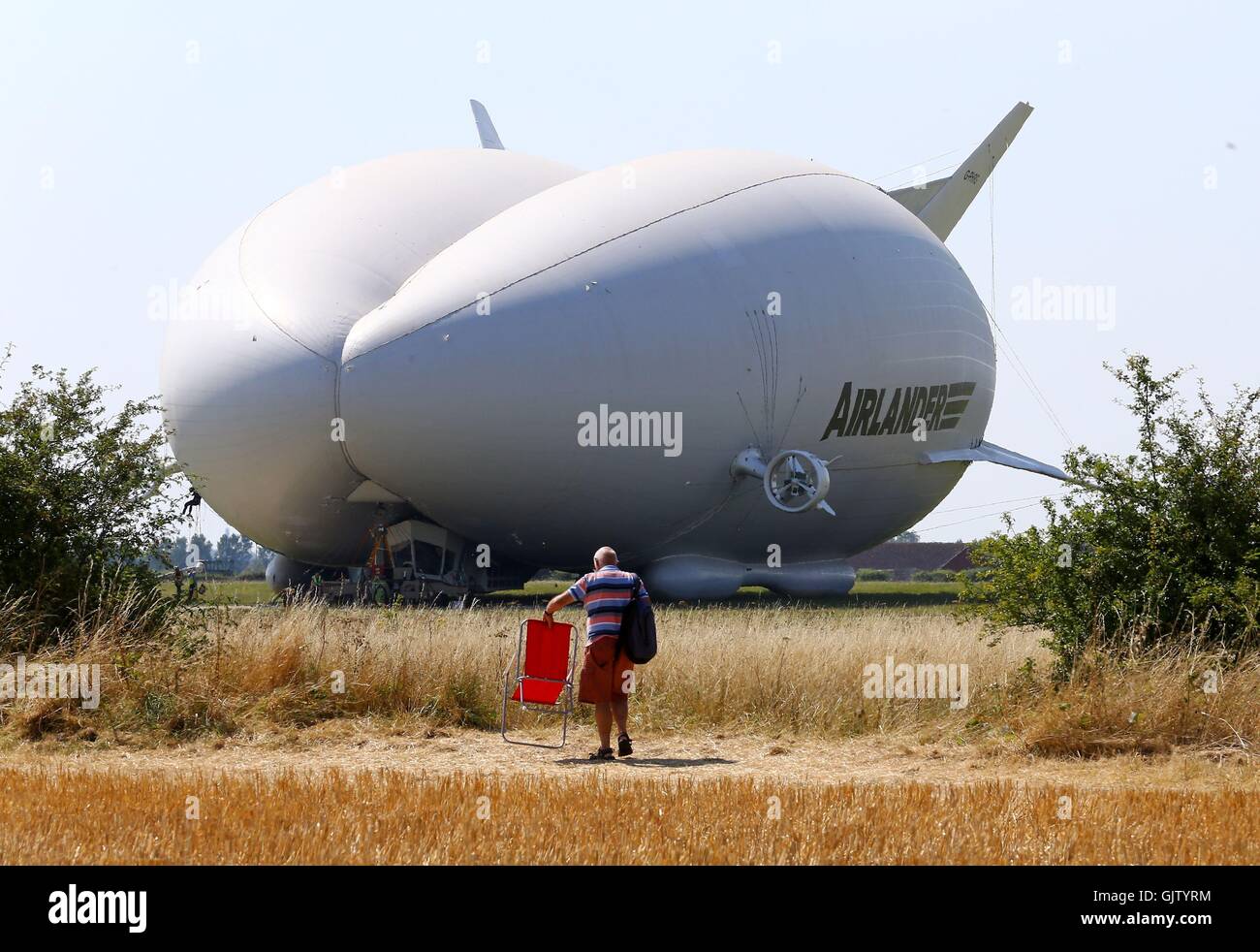 A man takes his seat as preparations are made for the maiden flight of the Airlander 10, the largest aircraft in the world, at Cardington airfield in Bedfordshire. Stock Photo