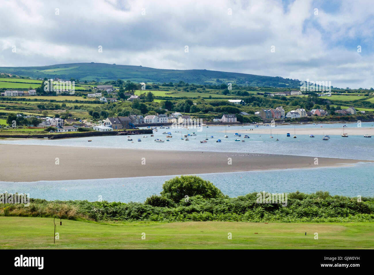 View across golf course and Afon Nyfer river estuary to Newport Sands and village at high tide. Newport Pembrokeshire Wales UK Stock Photo