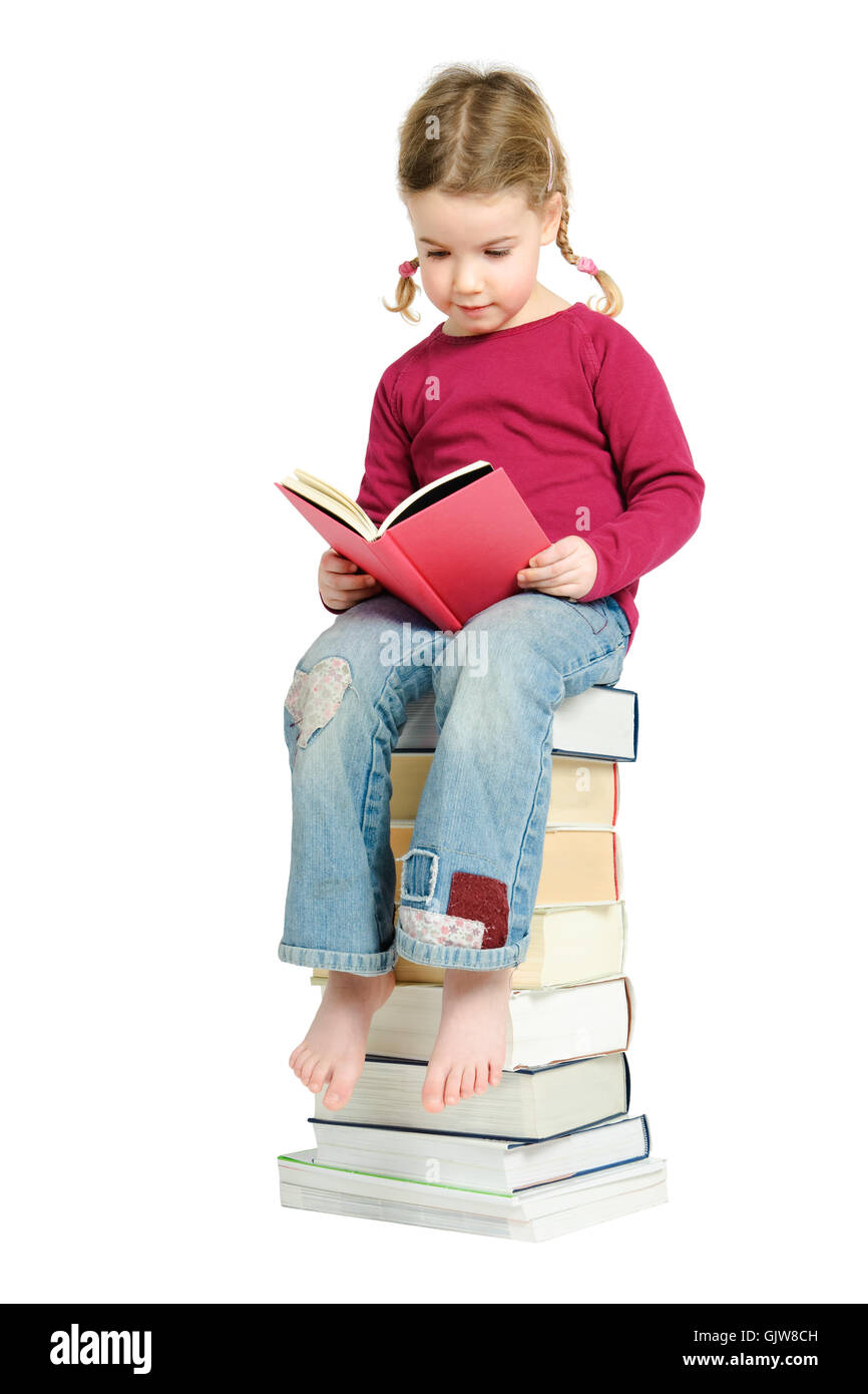 child on a pile of books Stock Photo