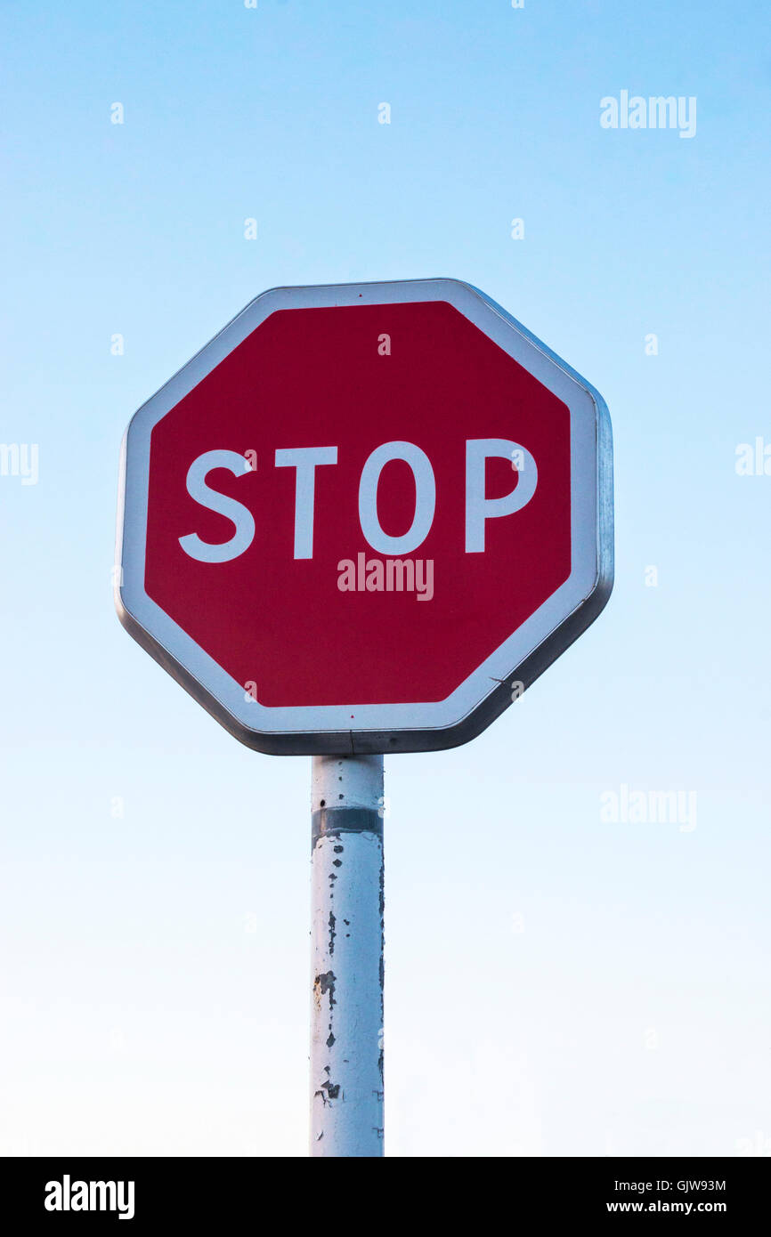 iconic red Stop sign against blue sky Stock Photo - Alamy