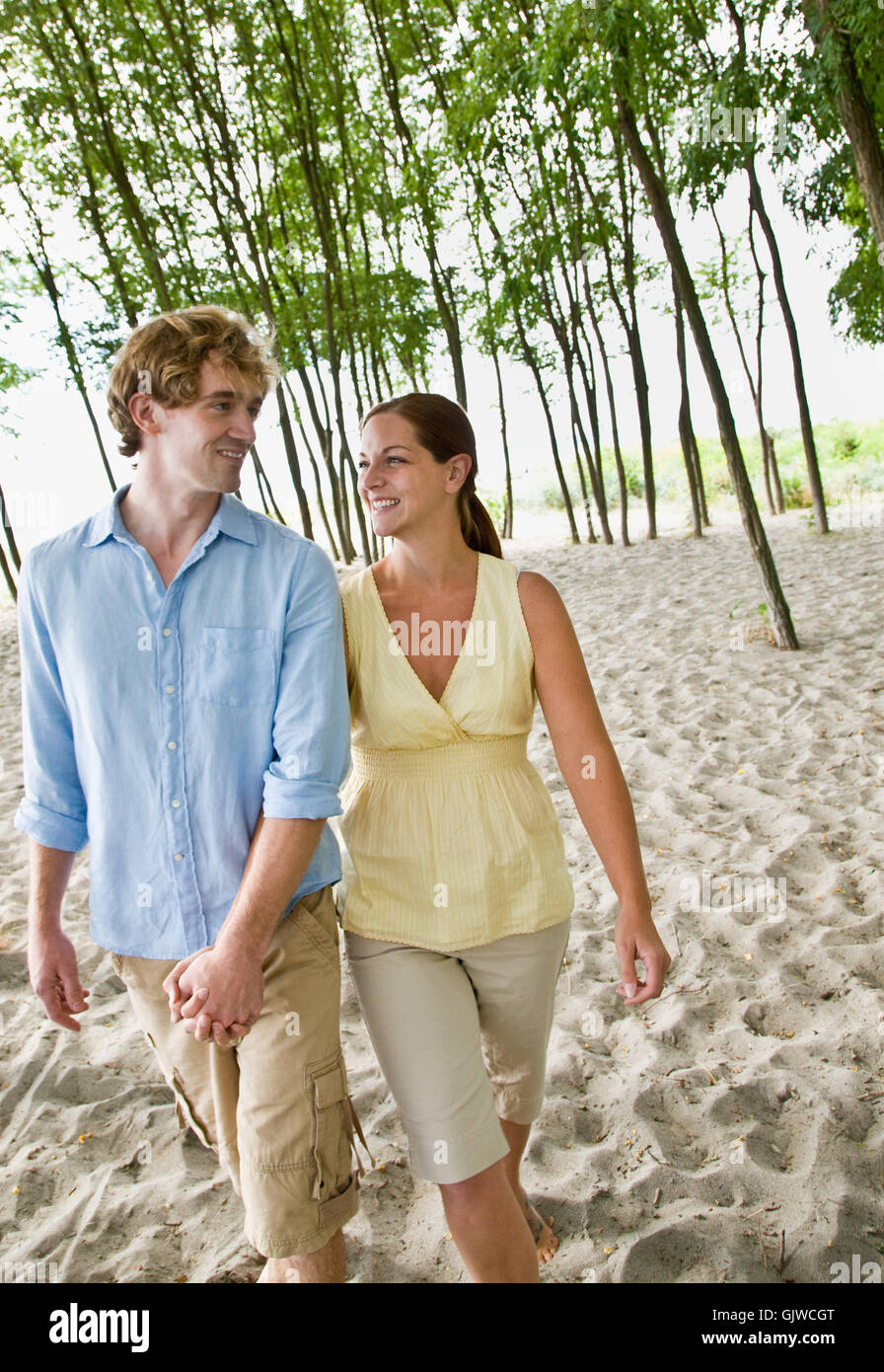 Woman younger man holding hands hi-res stock photography and images - Alamy