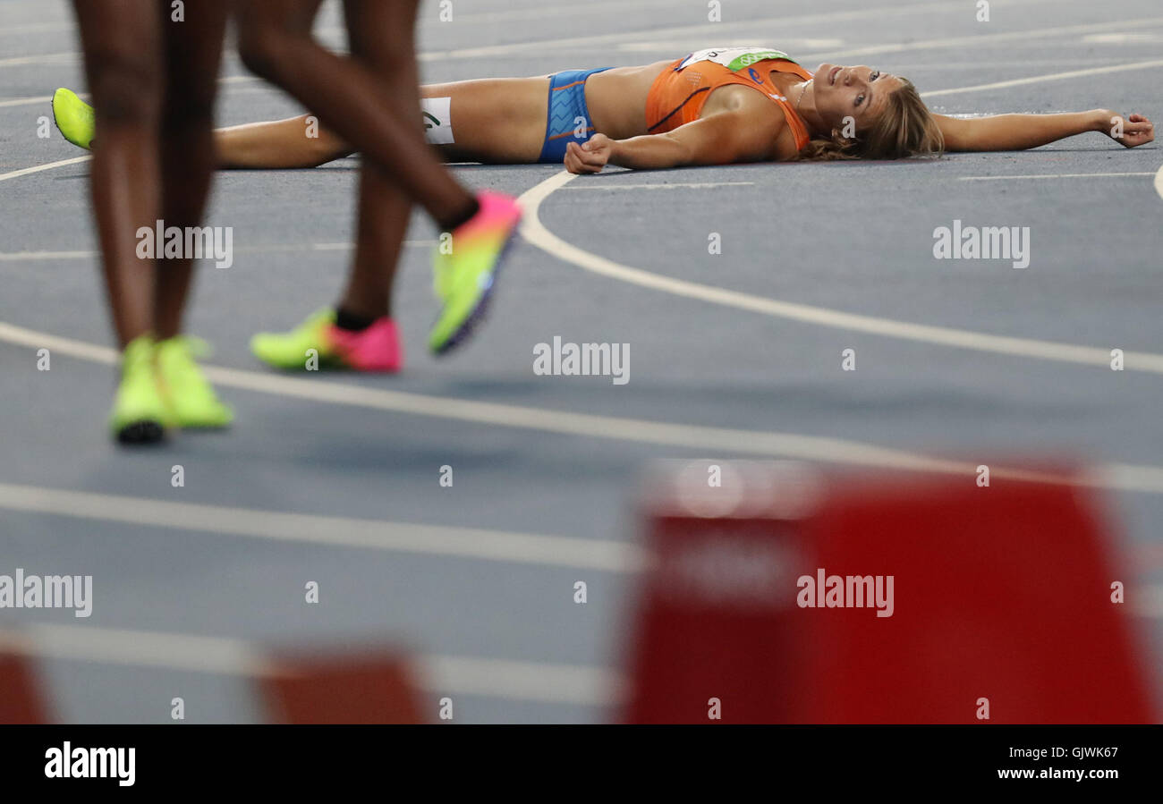 Rio de Janeiro, Brazil. 17th Aug, 2016. Silver medalist Dafne Schippers of the Netherlands lays on the floor after finishing the Women's 200m Final of the Athletic, Track and Field events during the Rio 2016 Olympic Games at Olympic Stadium in Rio de Janeiro, Brazil, 17 August 2016. At right bronze medalist Tori Bowie of the USA and at left Marie-Josee Ta Lou of Côte d'Ivoire. Photo: Michael Kappeler/dpa/Alamy Live News Stock Photo
