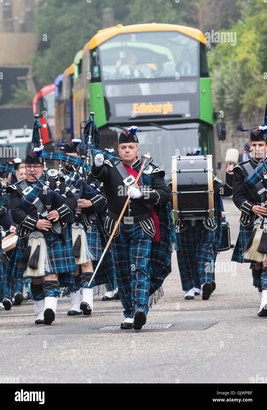 Edinburgh, Scotland, UK. 18th August, 2016. Military Tattoo pipers unveil new open-top tour buses. Lothian Buses has invested in 30 new open-top double deck vehicles for Edinburgh Bus Tours. The buses will begin operating across three of its routes in the coming weeks. Credit:  Richard Dyson/Alamy Live News Stock Photo