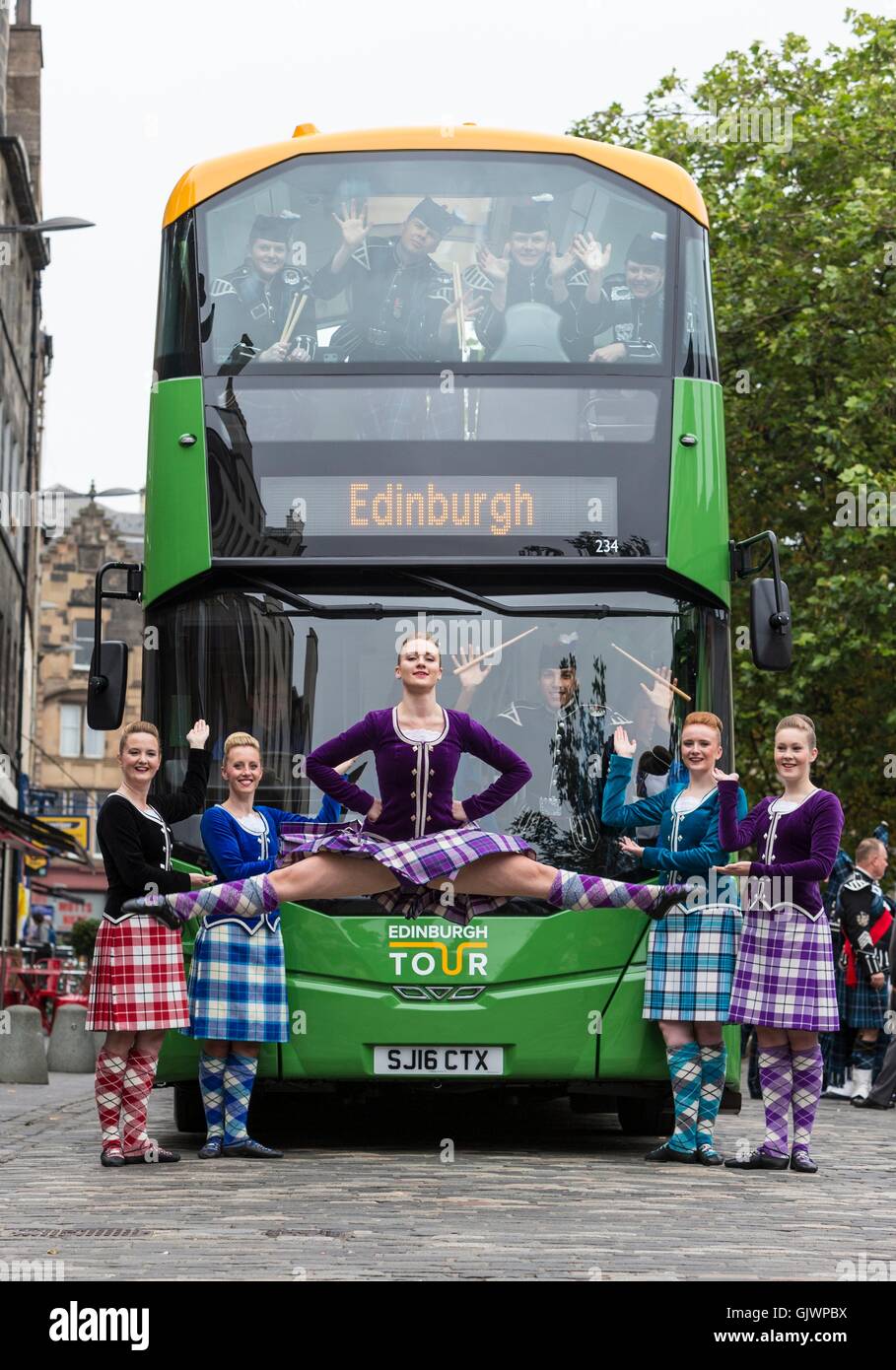 Edinburgh, Scotland, UK. 18th August, 2016. Military Tattoo pipers unveil new open-top tour buses. Lothian Buses has invested in 30 new open-top double deck vehicles for Edinburgh Bus Tours. The buses will begin operating across three of its routes in the coming weeks. Credit:  Richard Dyson/Alamy Live News Stock Photo