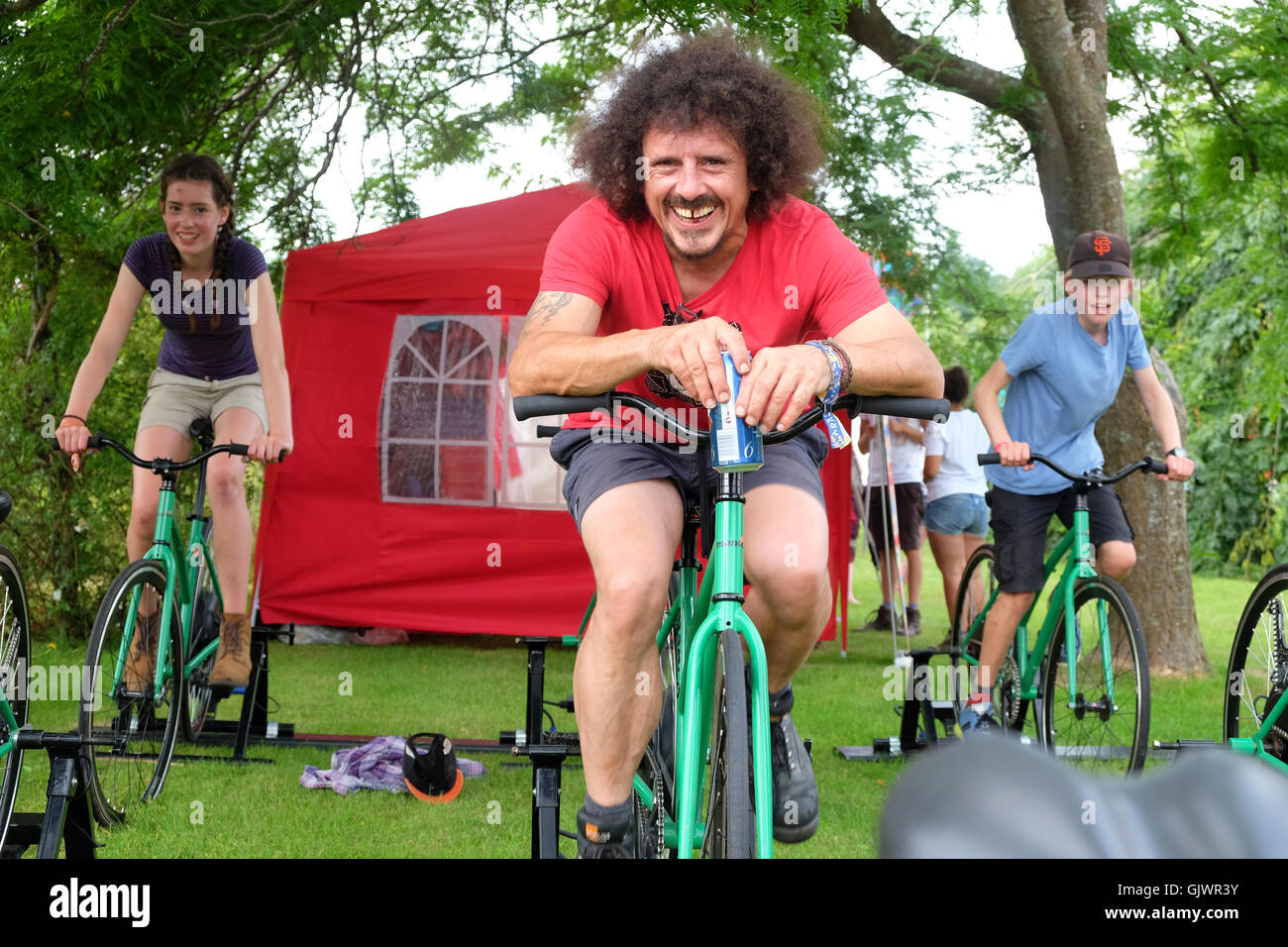 Green Man Festival, Brecon Beacons, Wales, UK August, 2016 - Peddle power phone battery charging bikes helped along by a beer too. Peddle the static bicycle to charge mobile phone batteries. The four day music and arts festival runs until Sunday. Stock Photo