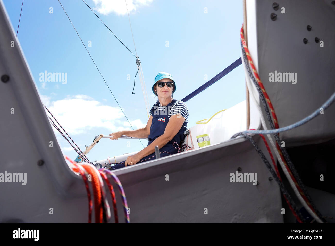 Woman helming sailing boat Stock Photo