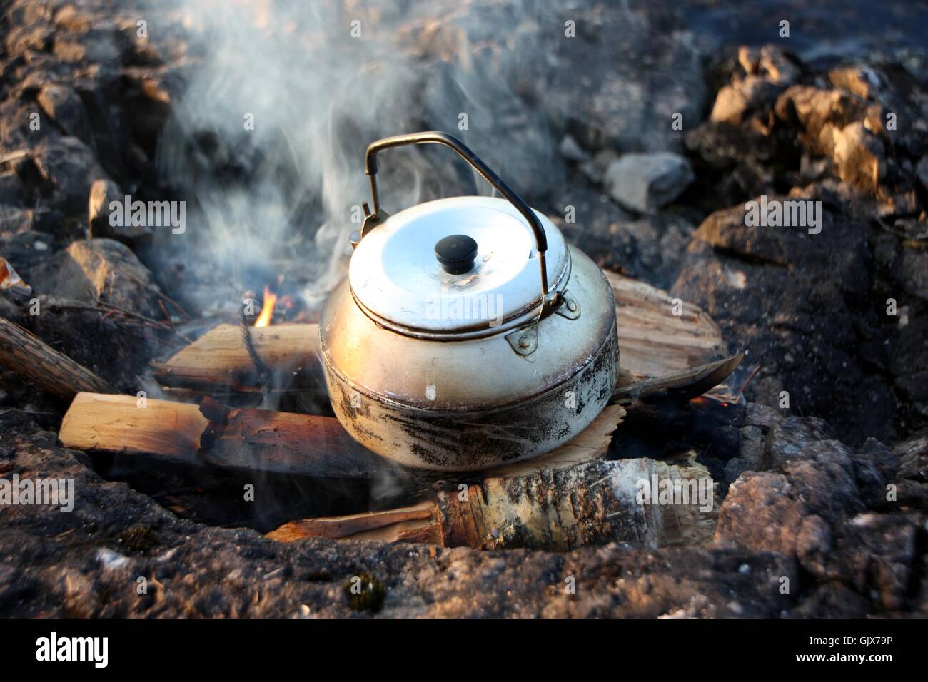 Low angle shot of a tea kettle over an open flame, capturing the essence of  traditional tea brewing and the warmth of the fire. 28781591 Stock Photo at  Vecteezy