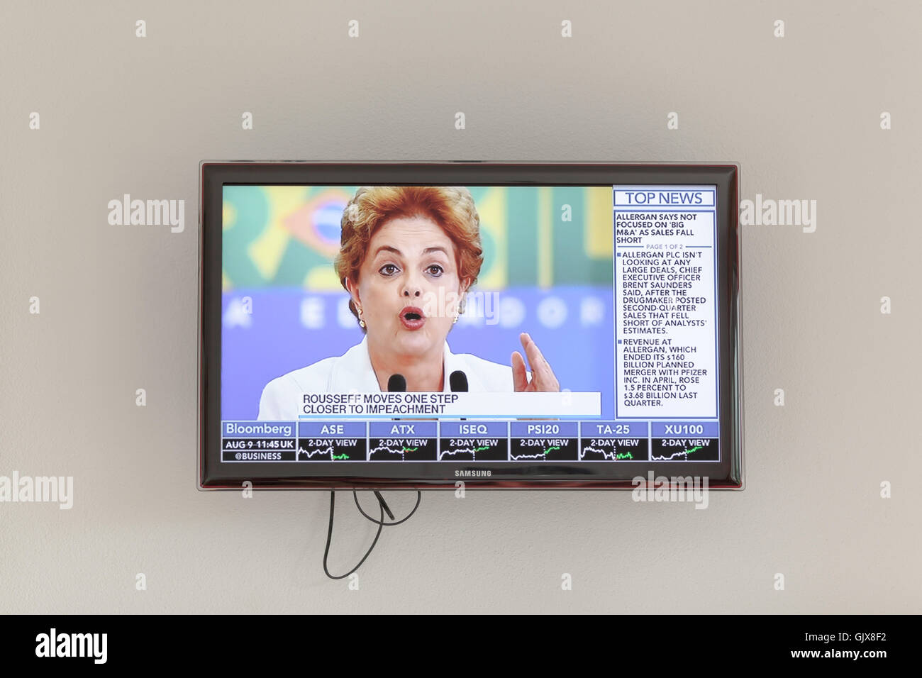 A flat TV screen Samsung on a white wall showing news Dilma Rousseff Stock Photo
